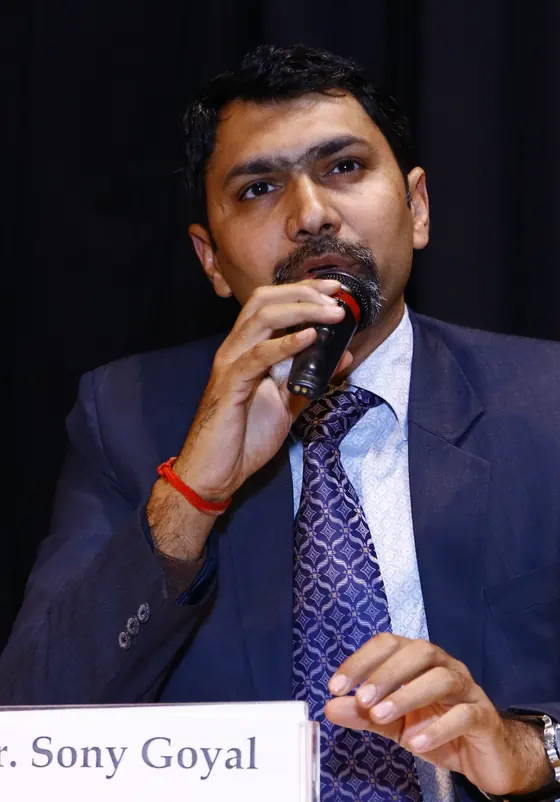 Mr. Sony Goyal speaking into a microphone at an event